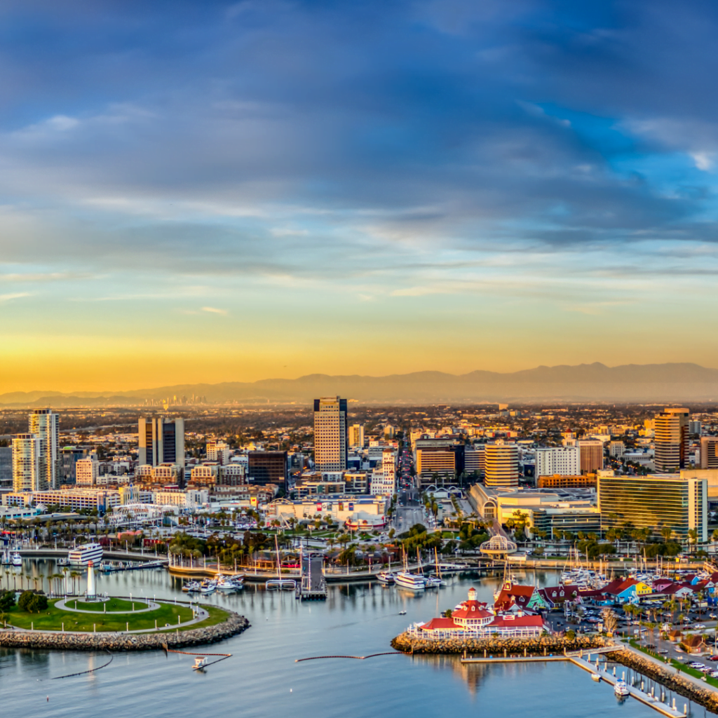 Panoramic view of a bustling coastal city at sunset, highlighting potential real estate prospects for FHA loan buyers.